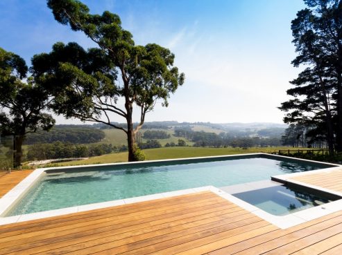 A partially above the ground X Trrainer pool and spa combo