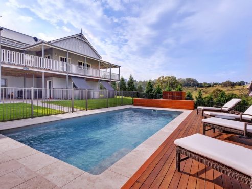 Beautiful X Trainer swimming pool with decking around and stunning views