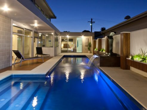 Compass Pools Fastlane fibreglass lap pool with external steps and waterwall feature