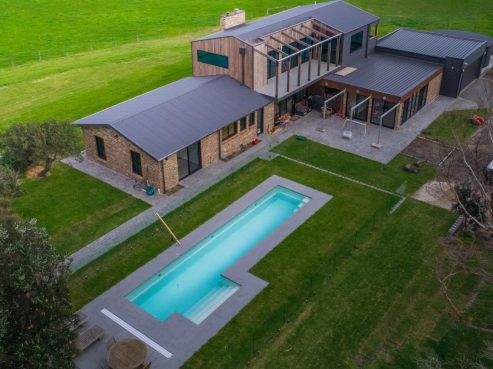 Compass Pools Fastlane fibreglass pool inground installation with steps on side