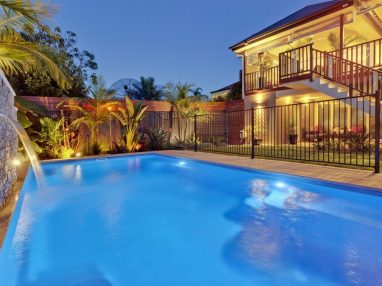 Compass X Trainer swimming pool with water wall and lights on