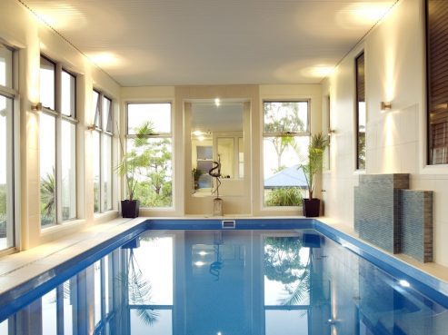 Indoor Compass X Trainer fibreglass pool with the Vantage self cleaning system and pool lights on