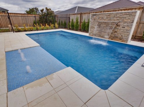 X Trainer swimming pool with a water wall feature and Sunpod