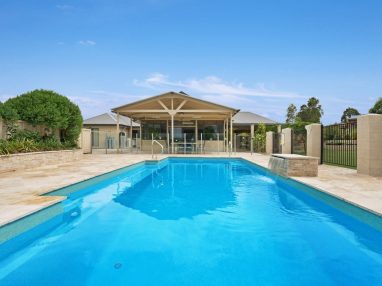 A family friendly pool design with a Vogue self cleaning Fibreglass Pool Sydney and water wall feature