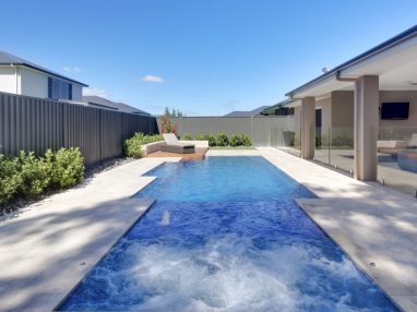 Pool and spa combo with a Sunpod connecting the pool and spa