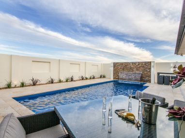 Vogue pool with a water feature water wall