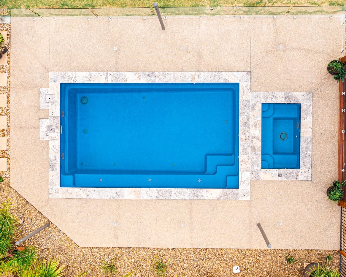 Inground Pools Compass Pools Sanctuary fibreglass pool 7.0m Pacific Bi luminite colour